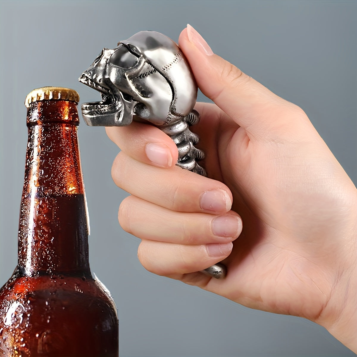 Skull-shaped metal bottle opener for beer and juice, perfect for home and restaurant use.