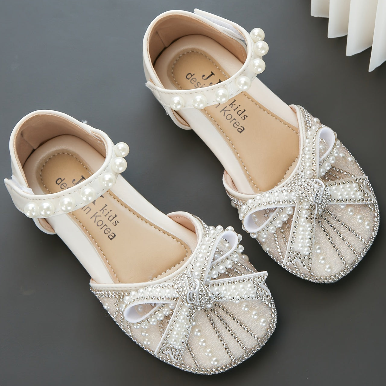 Sparkly bowknot flats with adjustable strap, durable TPR sole, comfortable for daily wear for girls aged 14 and under.