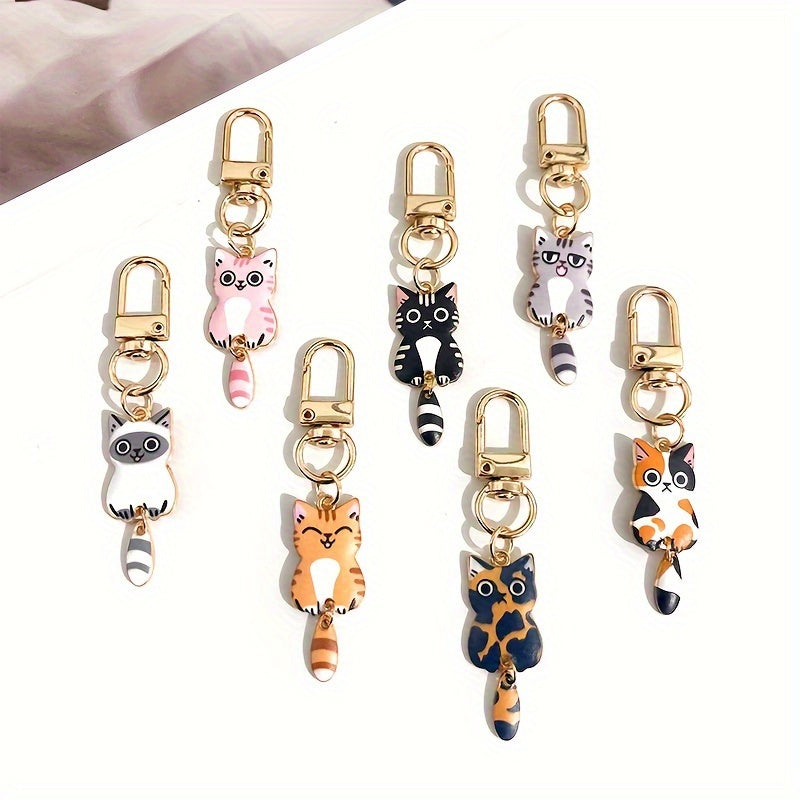 A collection of 7 adorable cat tail keychains made with zinc alloy featuring movable tails. Perfect as handbag charms and zipper pulls, these kitty keyrings make a fashionable accessory gift.