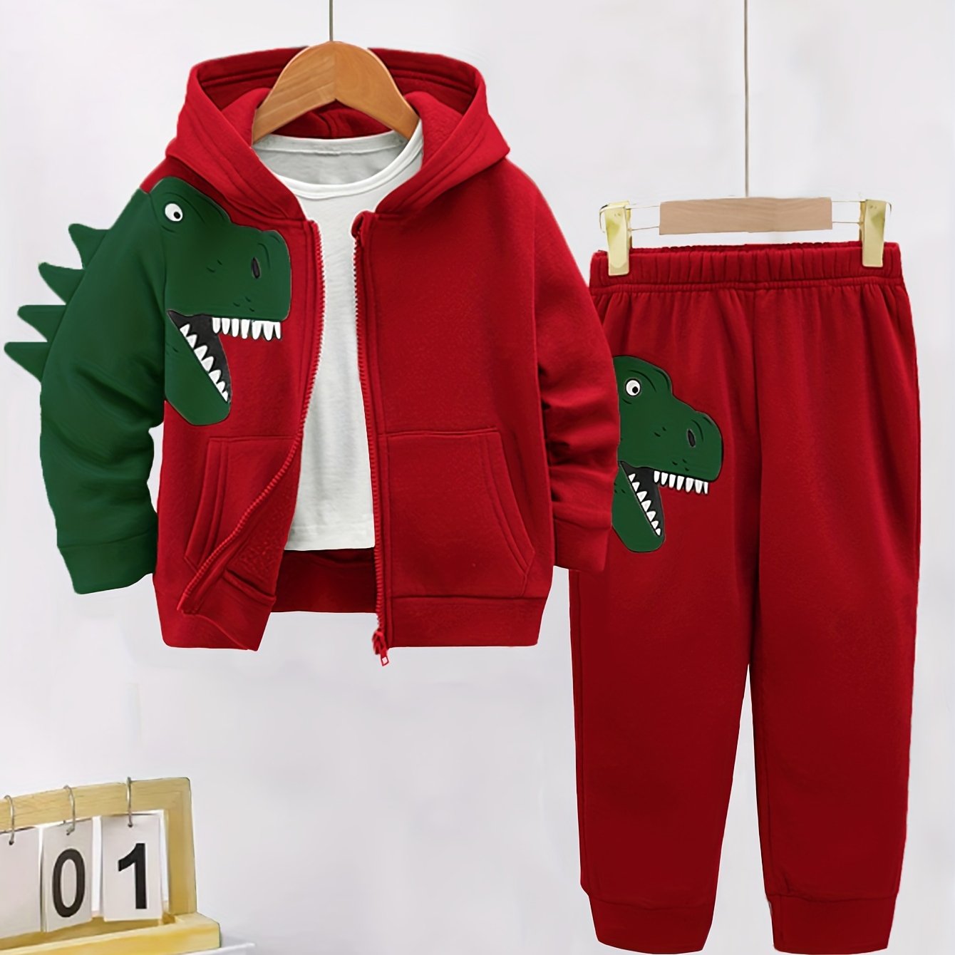 2-piece toddler set with fleece-lined hoodie and pants featuring dinosaur pattern. Perfect for autumn/winter outdoor activities, soft, cozy, and machine washable.