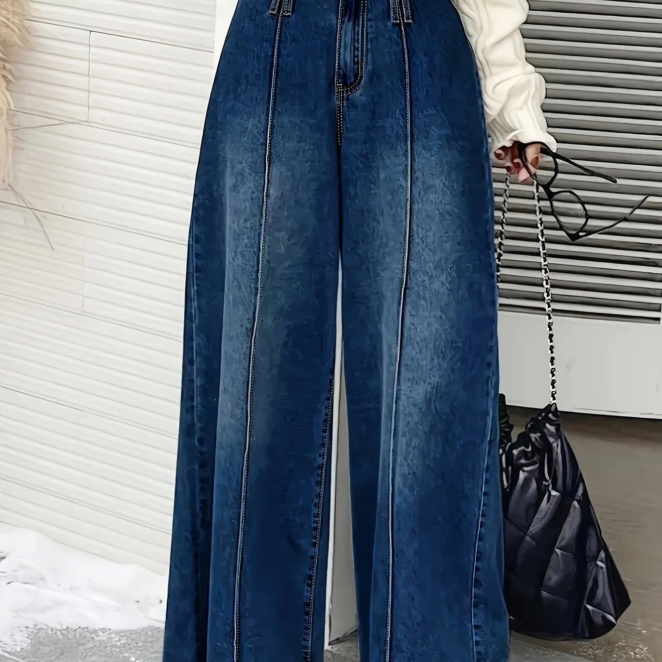 Women's wide-leg denim jeans with elastic waistband, loose fit, mid-rise, and slash pockets in light to dark blue gradient.