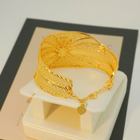 Wide bracelet with a flower pattern in the style of a noble palace, crafted in luxurious golden hollow design, perfect as a wedding or engagement gift.