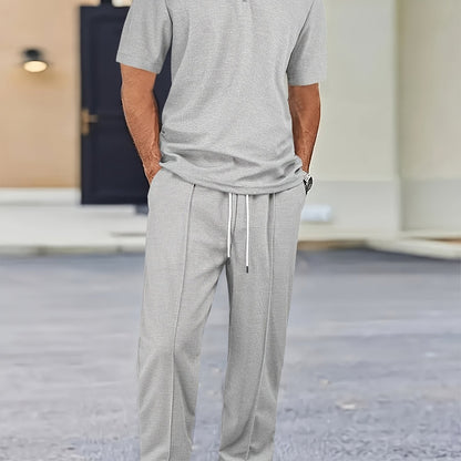 Men's casual outfit with waffle knit short sleeve zip-up shirt and drawstring pants in black. Made of polyester blend, perfect for spring/summer.