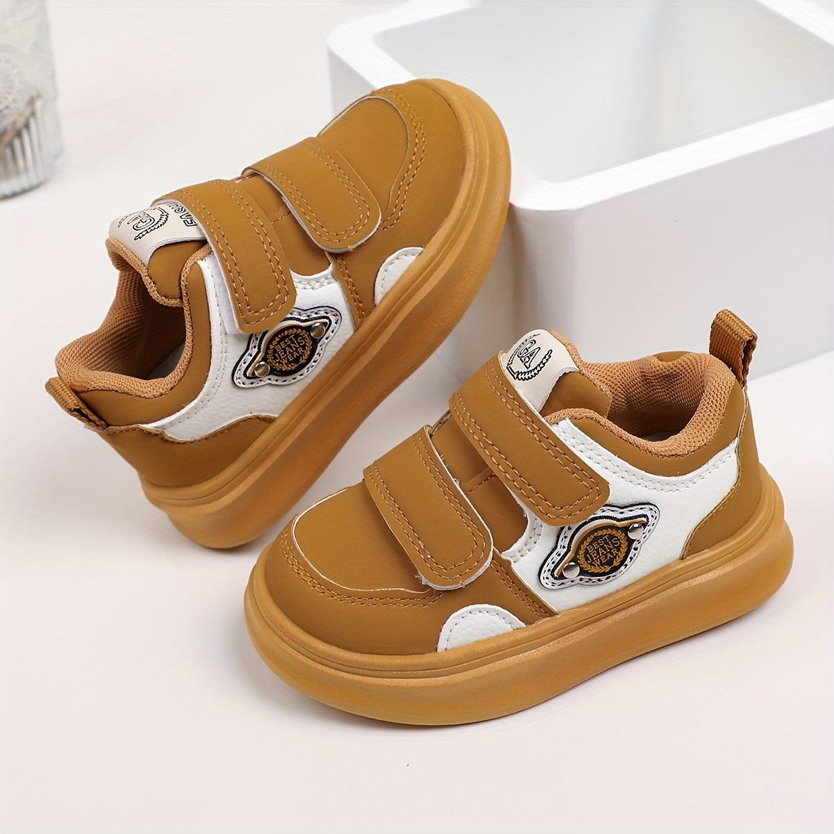 Casual low top sneakers for boys and girls with hook & loop closure, breathable faux upper, rubber sole, fabric insole, and round toe design.