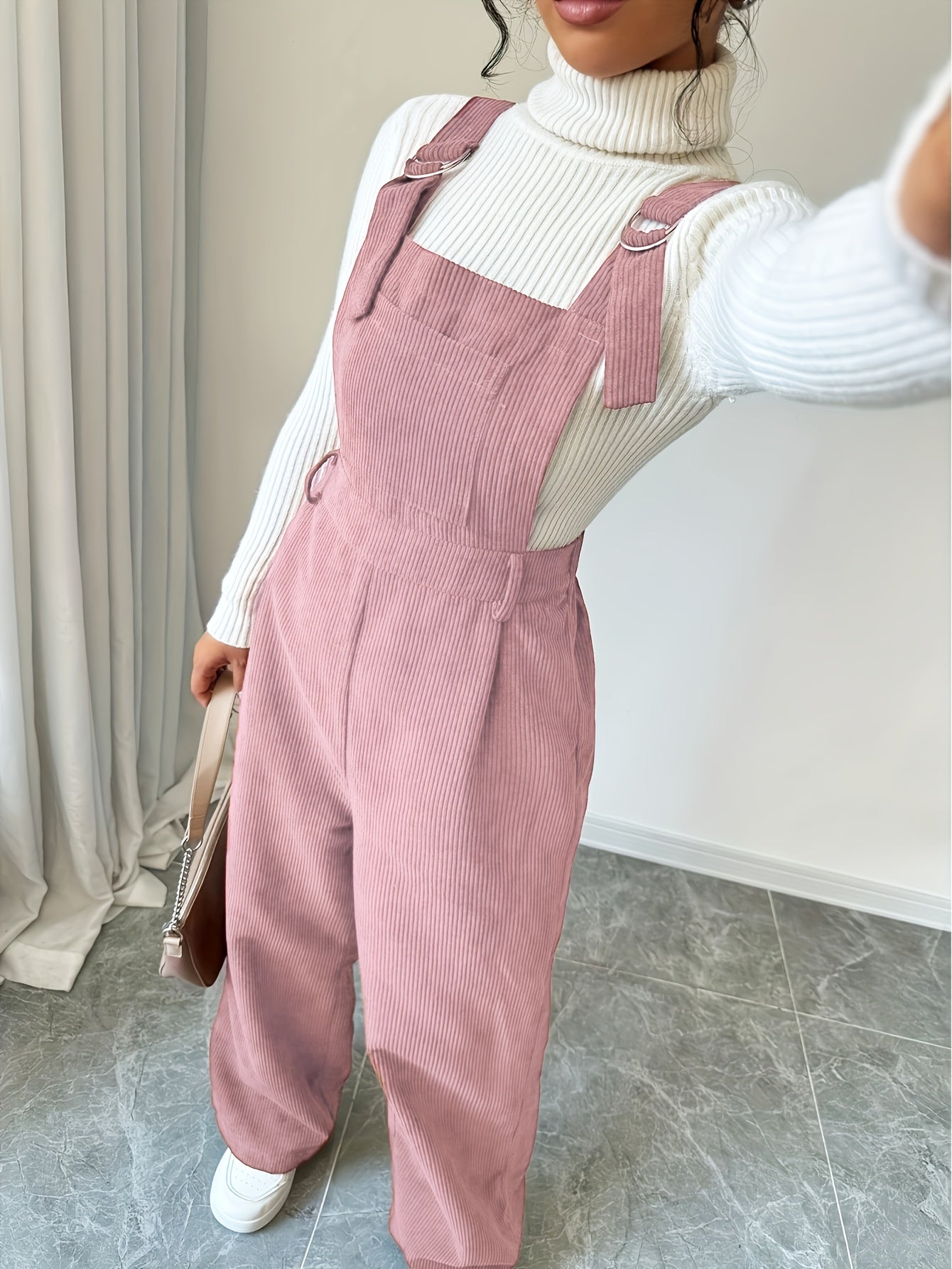 Spandex polyester jumpsuit for women with wide straps and button details, perfect for fall and winter.