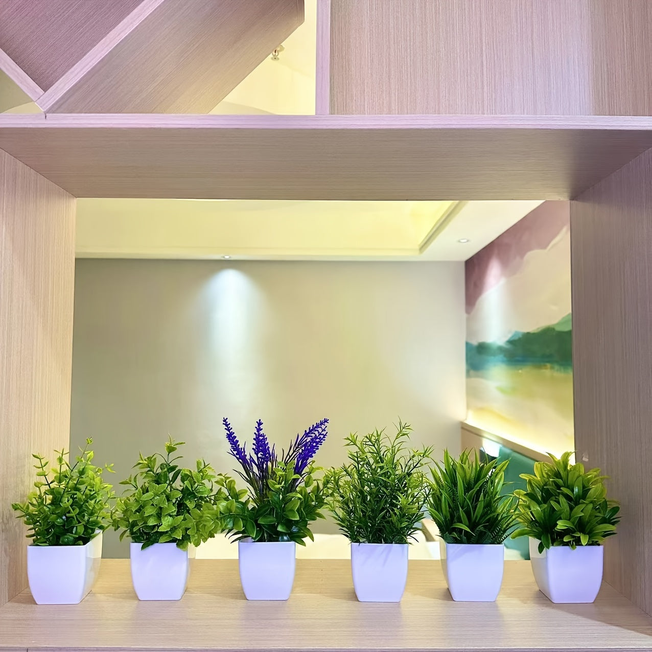 Small artificial white flowerpot with green plant, ideal for indoor home decoration. Can also be used as a mini green plant pot for offices, bathrooms, and bedrooms.