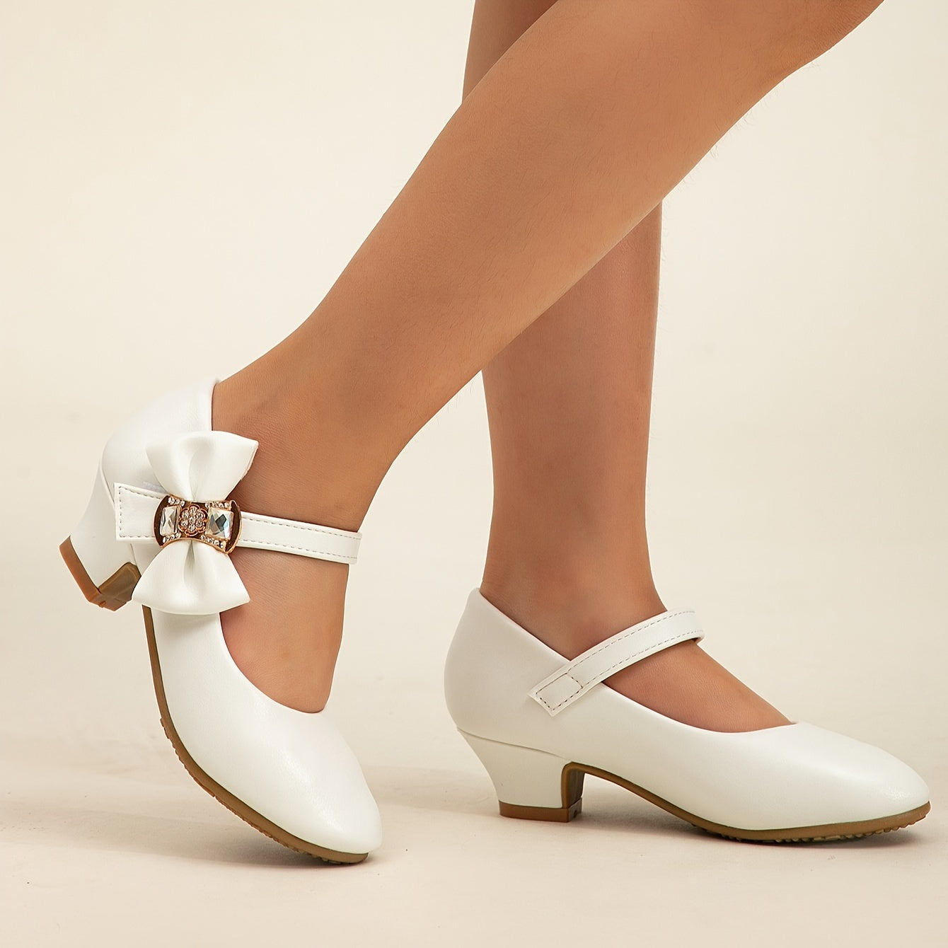 White princess shoes with bow, rhinestones, and high heels for girls' performances.