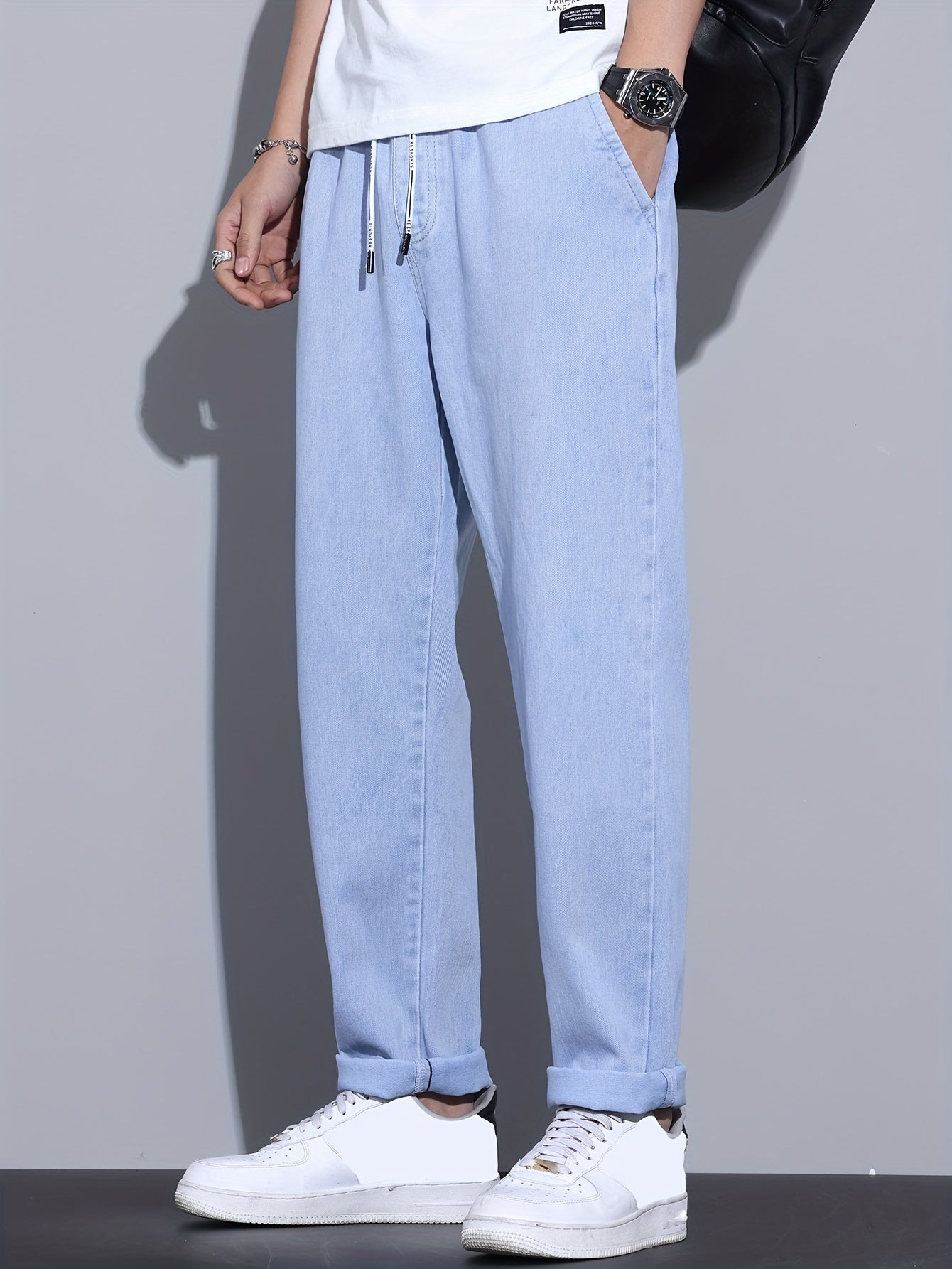 Men's light blue drawstring waist straight-leg jeans in glossy fabric, perfect for all seasons.