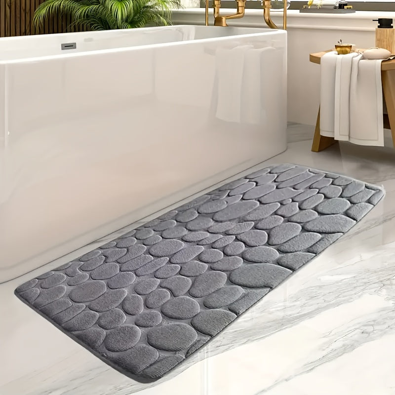 Soft coral fleece memory foam bath mat with geometric design, non-slip and absorbent. Machine washable polyester rug for bathroom and entryway decor.