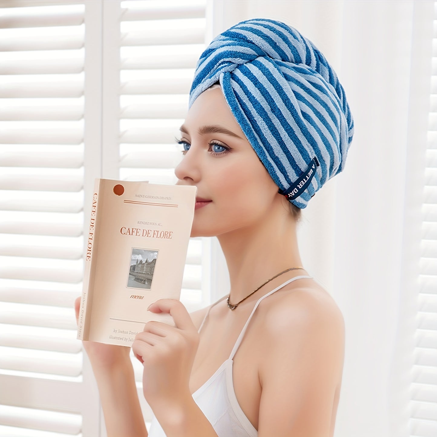 Modern blue and white striped hair towel wrap with button closure. Ultra-soft, absorbent, and low-shedding. Perfect for quick drying in a space-themed bathroom.