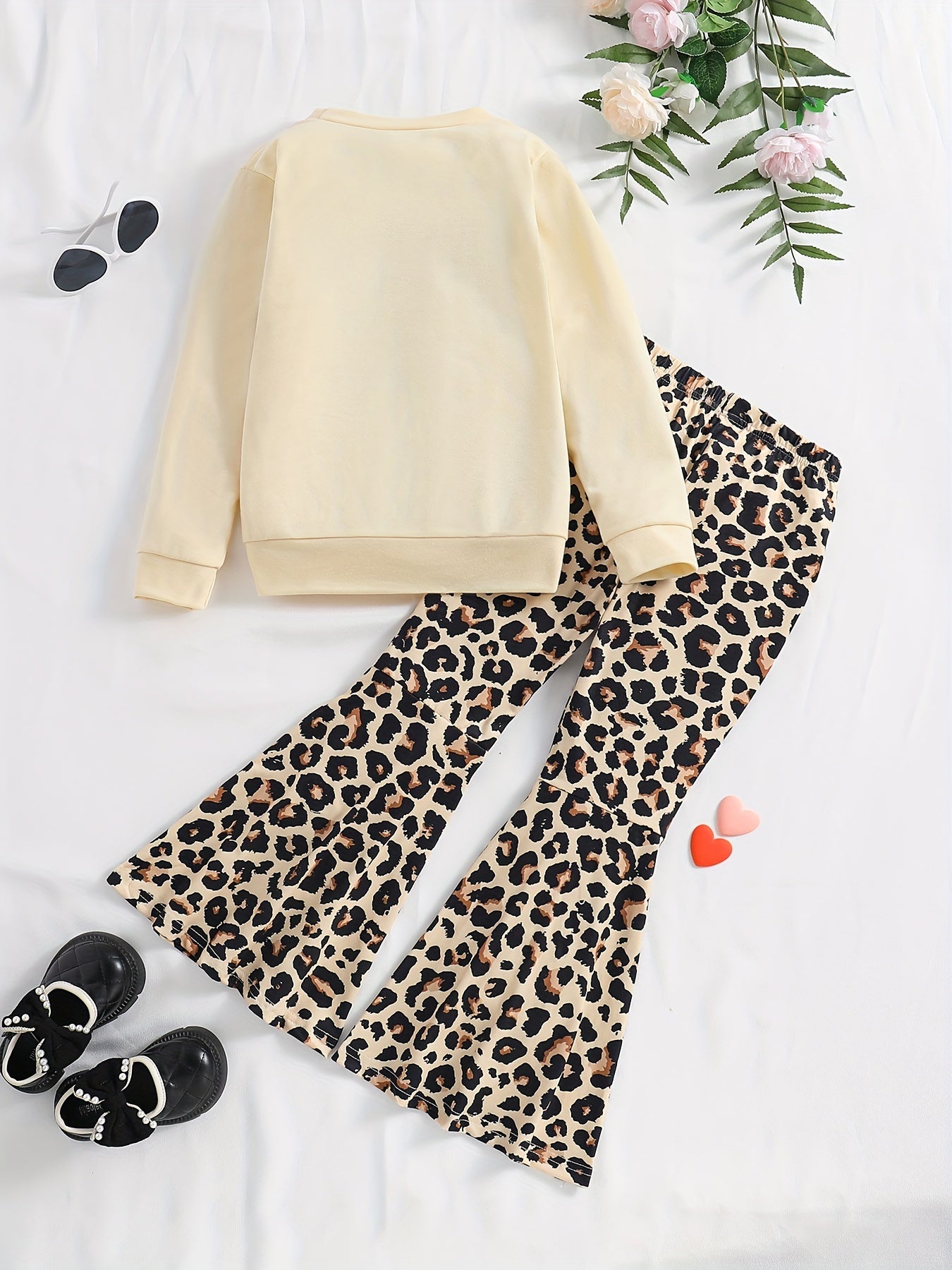 Girls' trendy 2-piece outfit includes a sweatshirt, leopard pattern flared pants, and sunglasses print. Perfect for spring and fall outdoor wear.