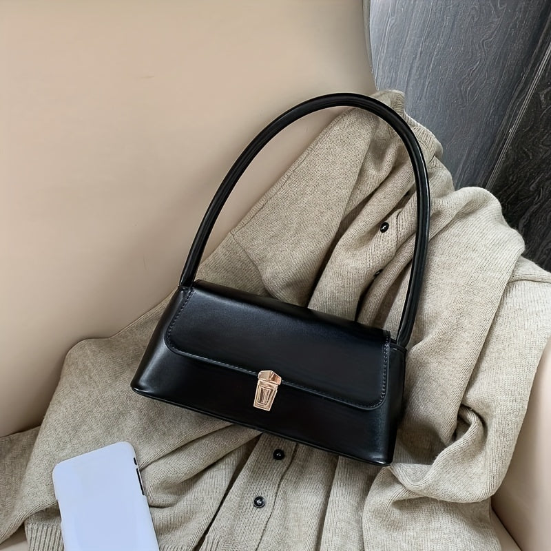 Chic black shoulder bag for women with French-inspired design and golden clasp. Versatile and stylish for everyday use with neat stitching detail.