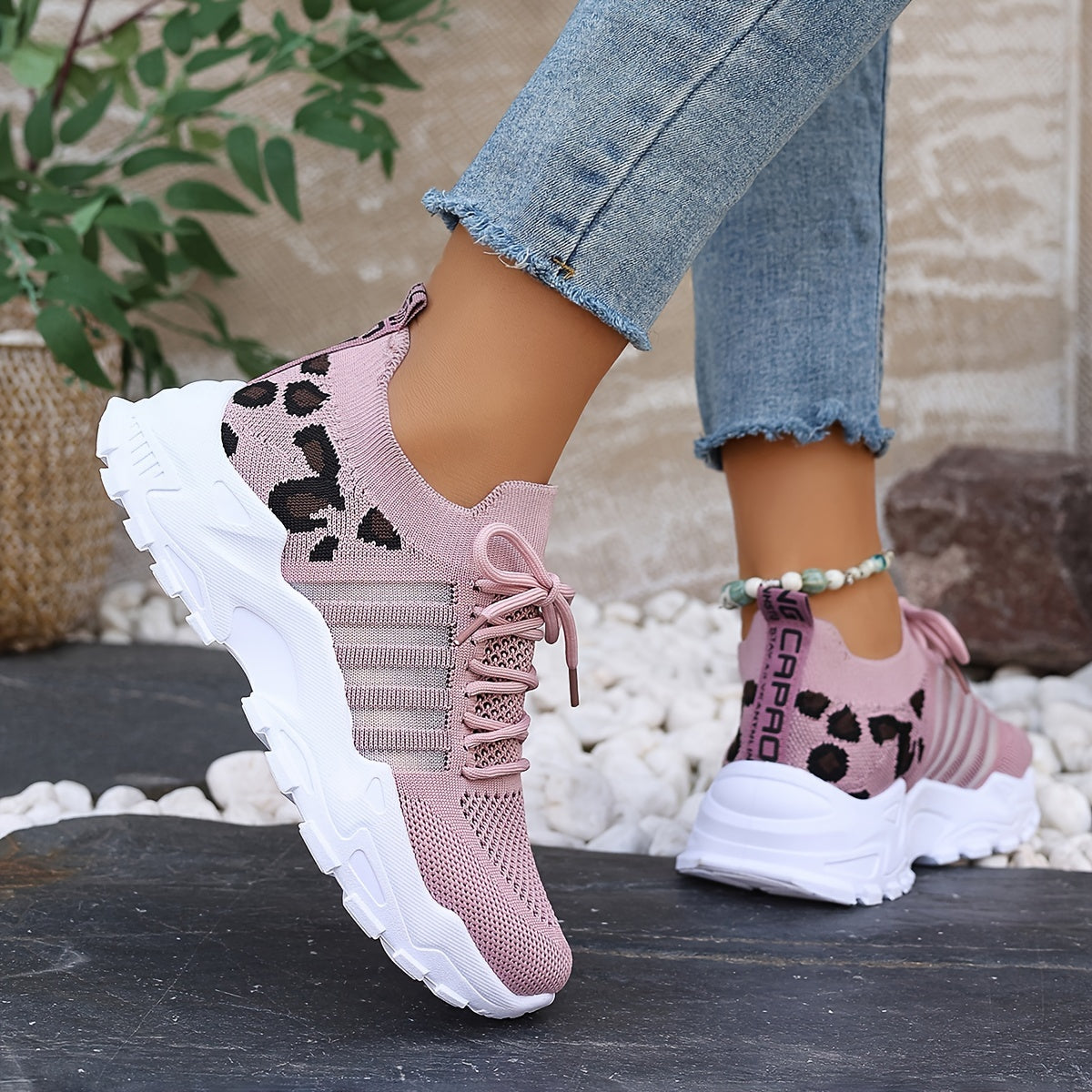 Breathable mesh leopard print sneakers with comfortable platform sole and stylish low-top design.