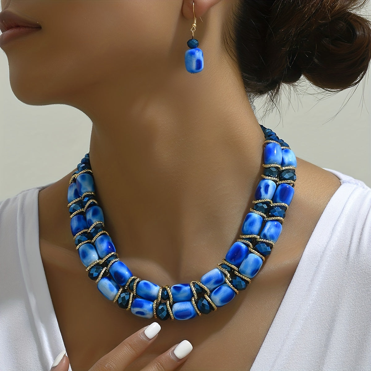 Complete your look with this Bohemian-style women's jewelry set featuring a 2-strand beaded necklace and earrings, suitable for everyday wear or special events.