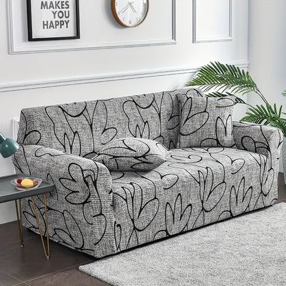 Elastic leaf-printed sofa slipcover for non-slip protection and decor in the living room.