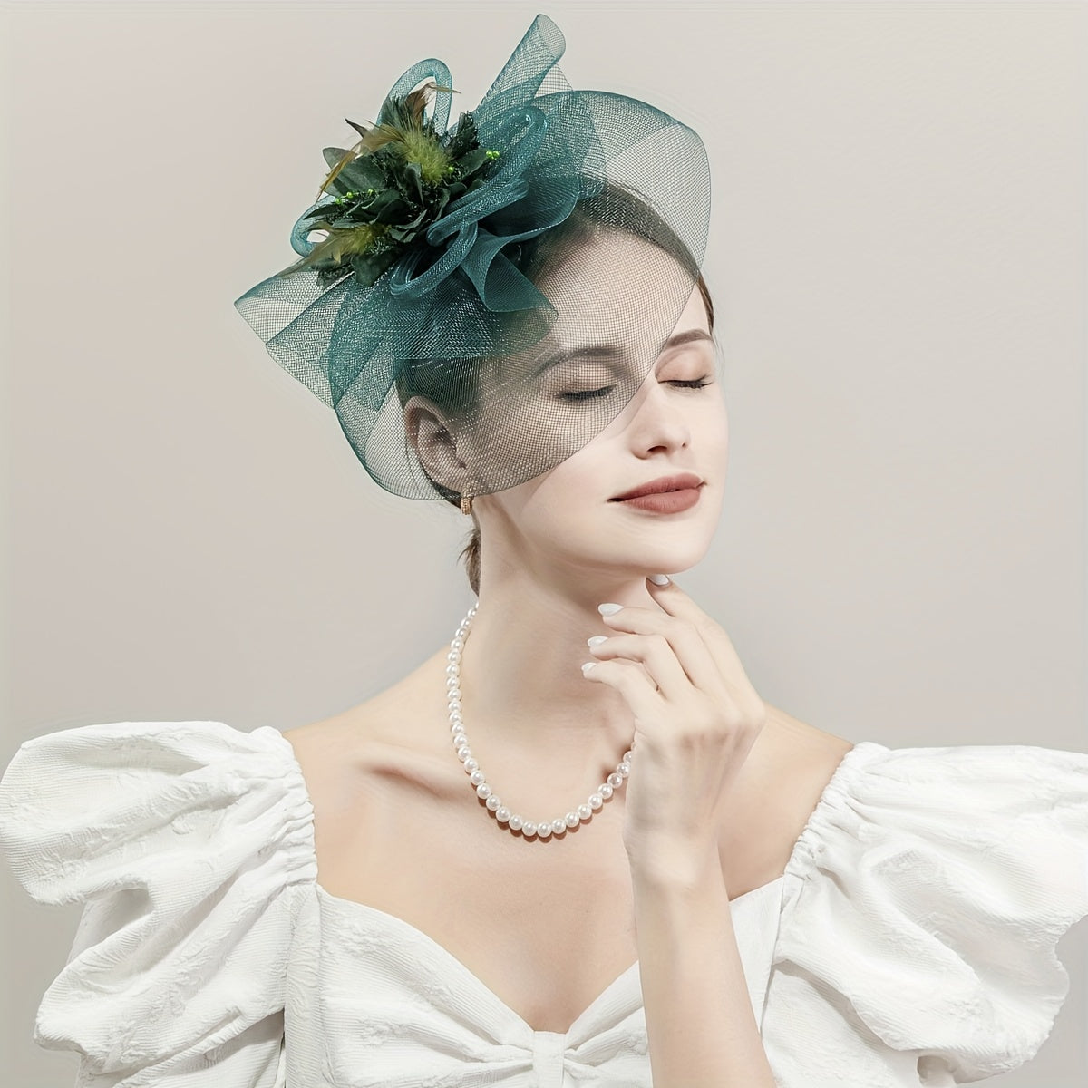 One piece of women's hair accessory featuring a mesh flower, faux feather detailing, and veil perfect for birthday parties, the Jockey Club, weddings, derby hats, and church events.