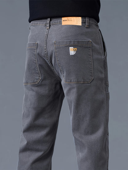 Men's fashion denim jeans made of 70% cotton, 28% polyester, and 1.3% elastane. Features a regular fit, mid waist, zipper fly, and all-season wear. Constructed with 300g/m² woven fabric