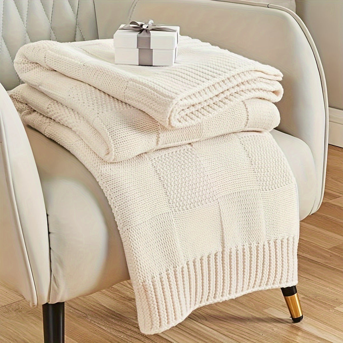 Soft and cozy knit throw blanket in white checkered pattern, perfect for couch or bed. Keep warm and stylish in any room with this knitted throw blanket.