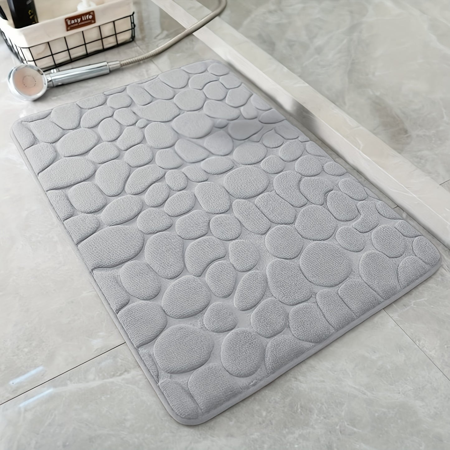 Pebble pattern bath mat in blue winter wonderland design. Non-slip, absorbent, machine washable, and fluffy.