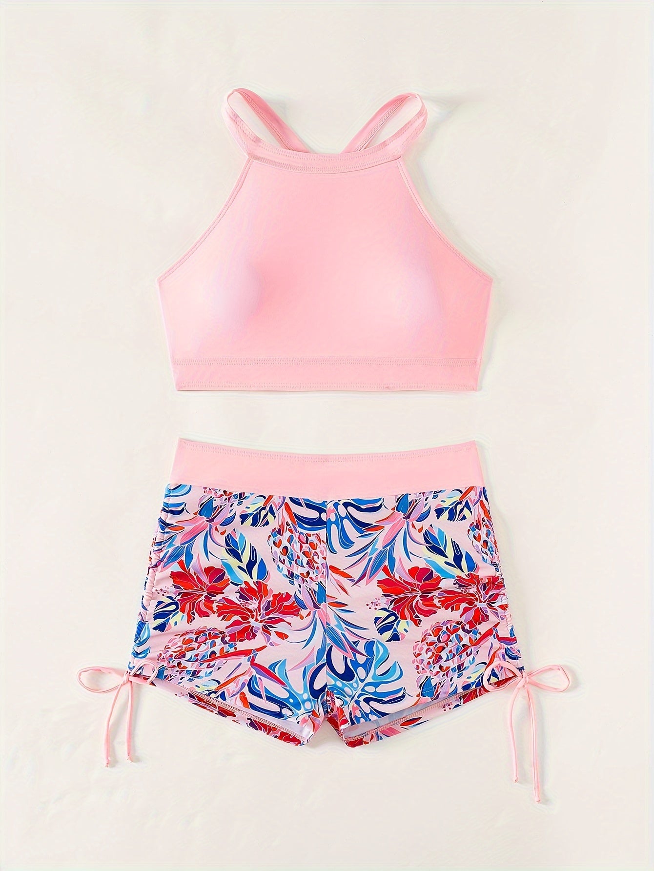 Conservative women's two-piece swimsuit with high-waisted shorts and ring-linked top for beach and hot spring wear.