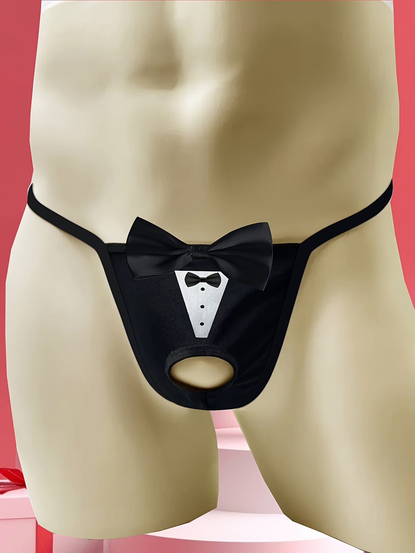 Sexy low-rise jockstrap for men with playful tie print and front bow detail. Breathable and stretchy black fabric with open crotch design for comfort and style.