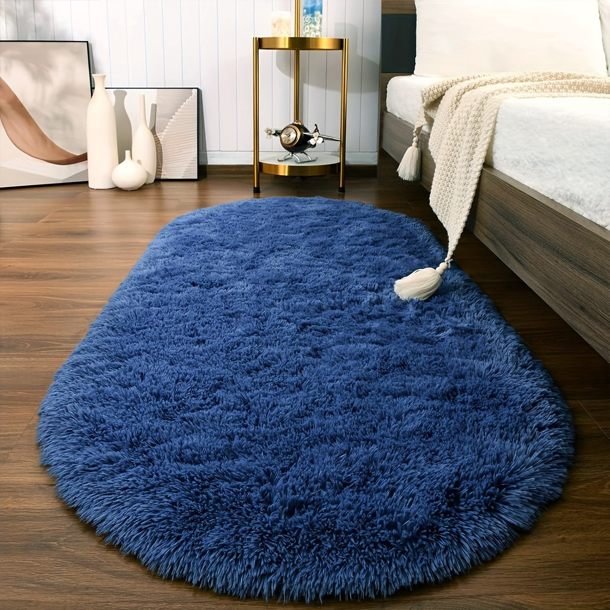 Soft and fluffy oval shaggy area rug, perfect for bedroom or living room. Made with skin-friendly thickened sponge and tufted polyester material. Durable and easy to maintain. Adds decorative touch to indoor spaces such as sofa, bedside, playroom, or