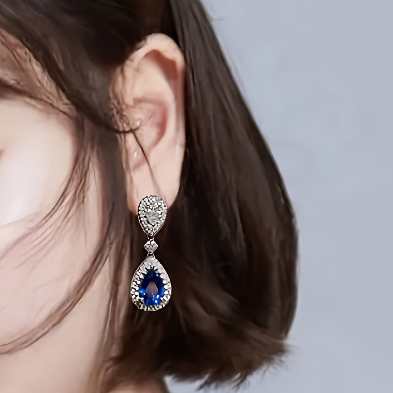 Exquisite and premium jewelry designed for women, showcasing a stunning water drop-shaped silvery earring adorned with shimmering zirconia stones. This elegant piece weighs around 3.9 grams and is ideal for special occasions and evening gatherings. A