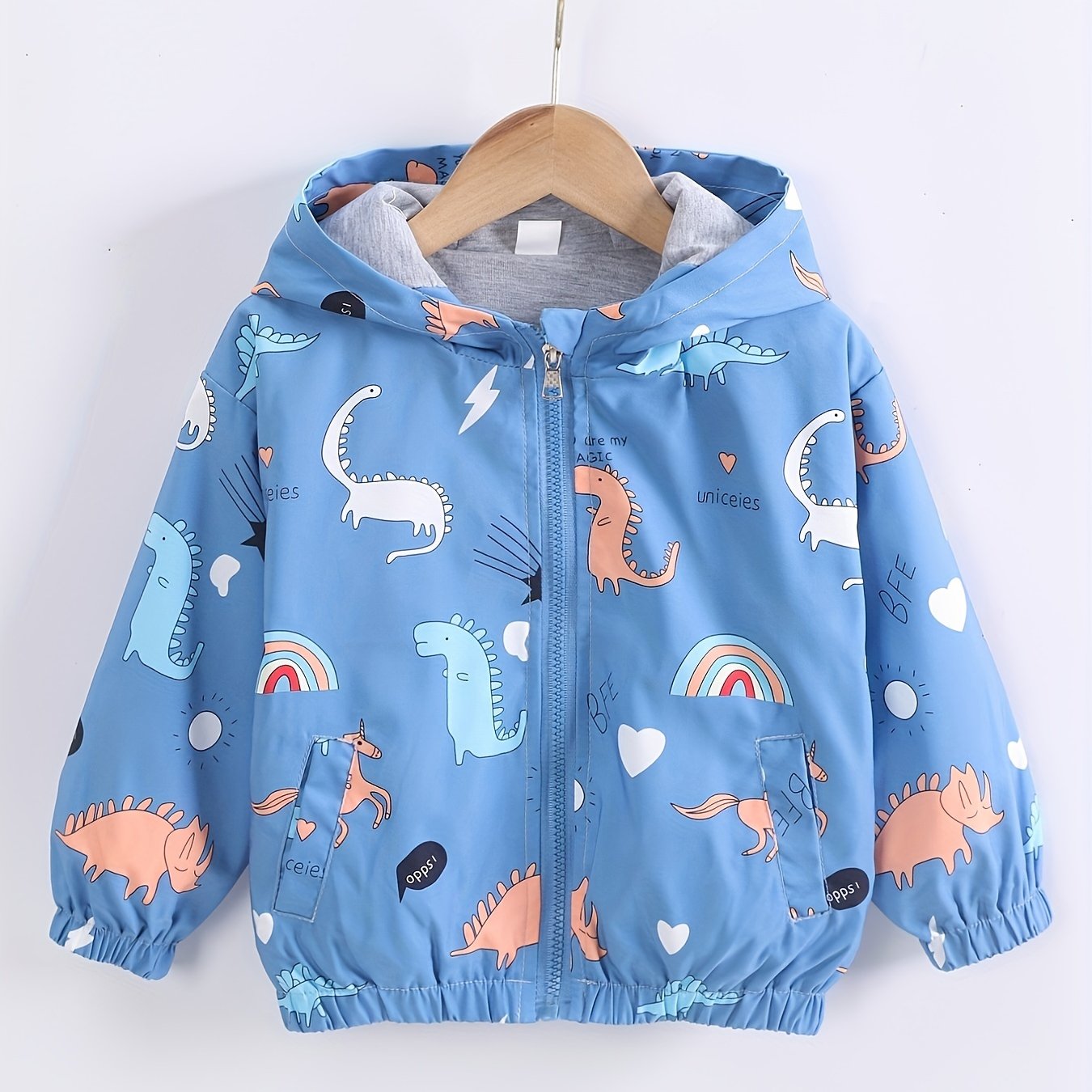 Boys hooded jacket with cartoon dinosaur and rainbow print, featuring long sleeves and zip-up closure, suitable for outdoor activities.