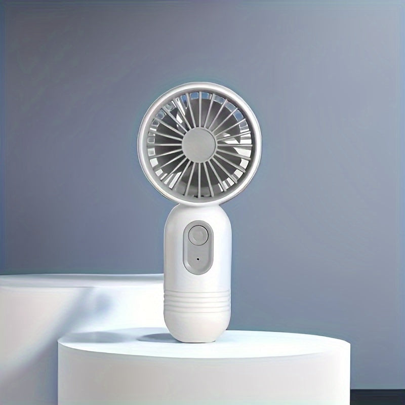 Small portable fan that is handheld and rechargeable via USB, light weight and quiet for use on desk or while traveling, ideal gift for the summer season.