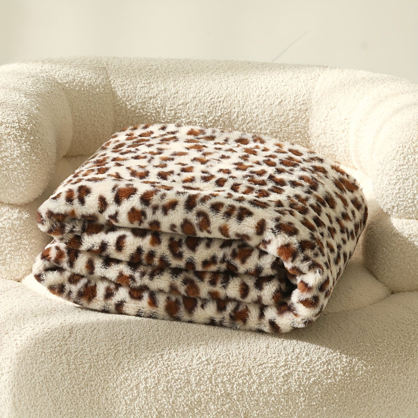 A versatile rabbit plush family blanket with a stylish leopard print design, perfect for all seasons and doubling as a cozy sofa blanket.