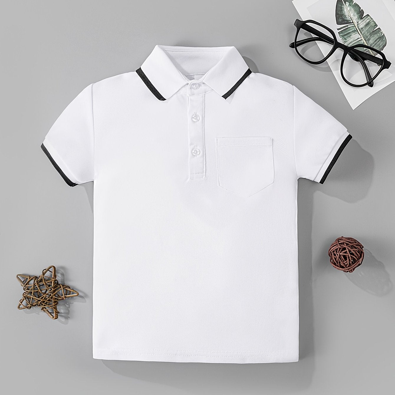 Boys' classic black and white shirt made of casual knit fabric, featuring short sleeves and a pocket detail, ideal for summer.