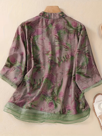 Women's floral print shirt with high neck, three-quarter sleeves, and cross hem. Made of polyester in a regular fit for weekend wear.