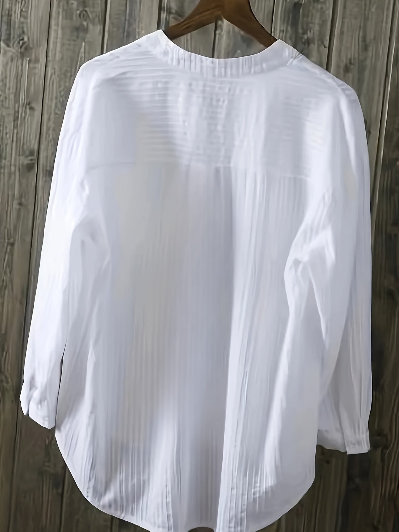 Machine washable women's white linen blend shirt with long sleeves, v-neck, and button detail.