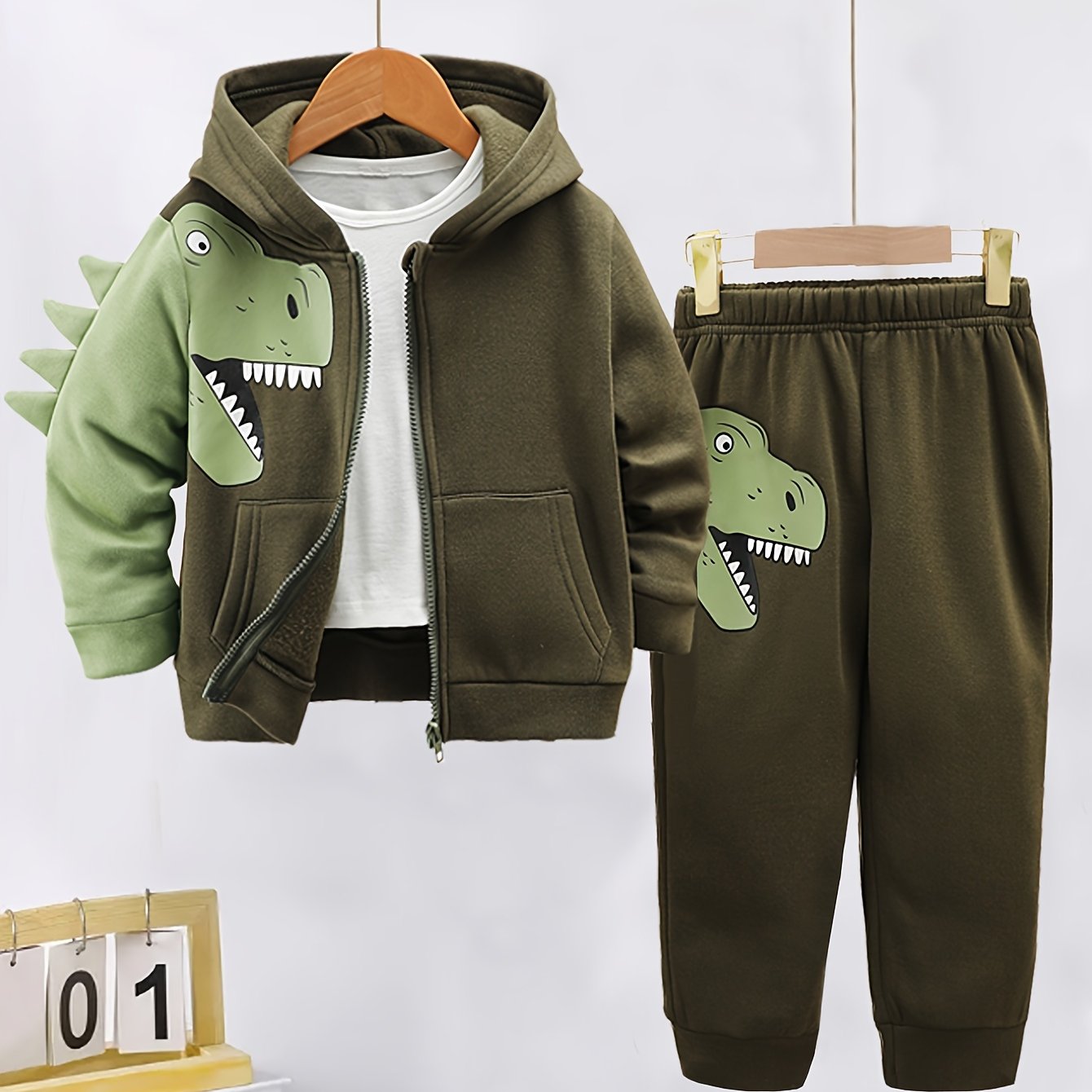 2-piece toddler set with fleece-lined hoodie and pants featuring dinosaur pattern. Perfect for autumn/winter outdoor activities, soft, cozy, and machine washable.