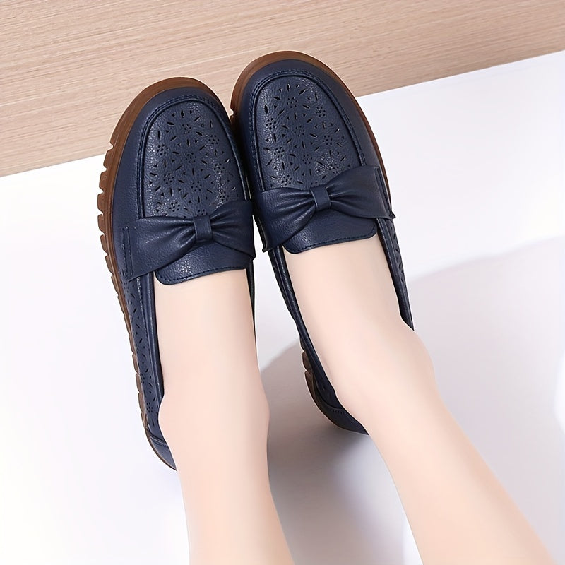 Women's breathable closed toe flat shoes with hollow out design.