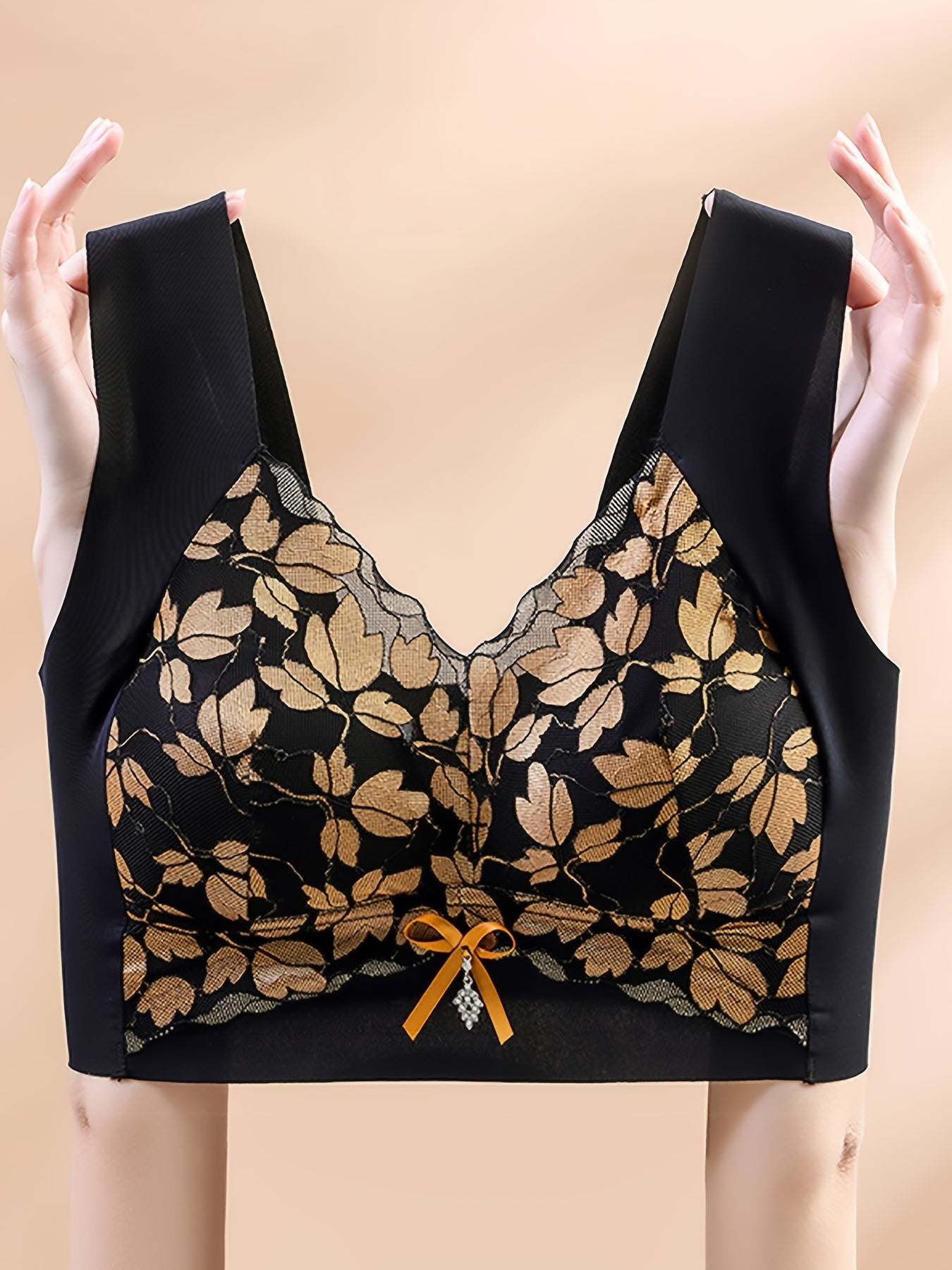 Polyamide and elastane bra with medium support, non-removable padding, plant pattern, contrast lace detail, wireless, scoop neck, and u-back design for spring/summer.