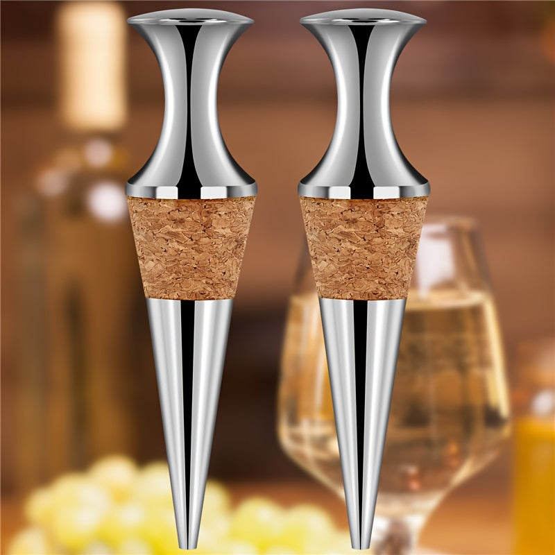 Two silver wine stoppers with wooden plugs.