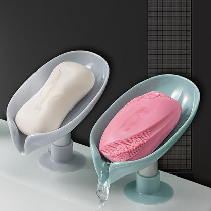 Suction cup soap dish with drainage for home organization and storage, suitable for kitchen and bathroom use.