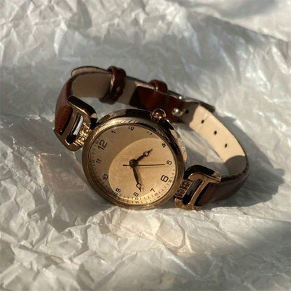 Elegant vintage-inspired women's watch with quartz movement and synthetic leather strap, non-rechargeable button battery.