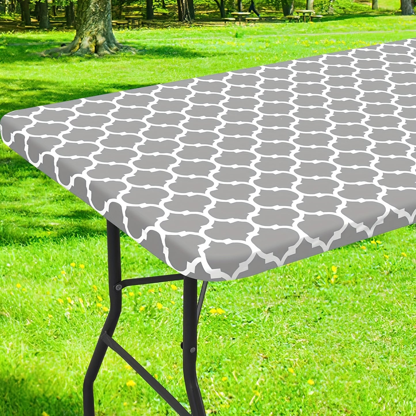 Waterproof vinyl table cover with flannel backing and elastic edge, featuring a gray and white geometric pattern. Ideal for indoor and outdoor use on home patio. Machine-woven fabric with easy-clean surface.