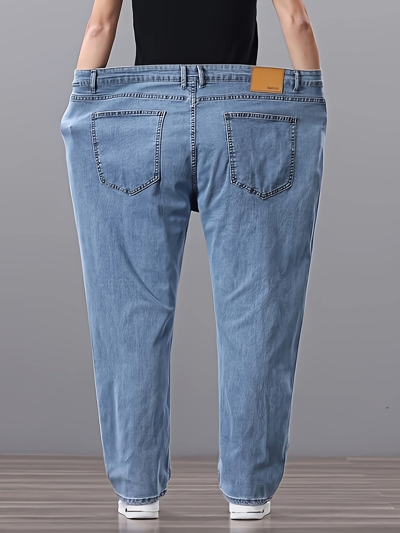 Men's high-waisted denim jeans with stretch fit in a solid color. Features regular fit, straight leg, and made of 45% cotton, 33% polyester, 1.5% spandex, 20.5% rayon. Lightweight at