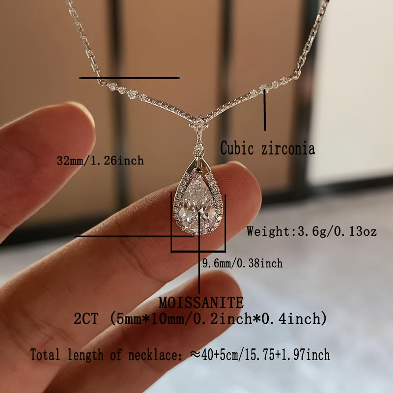 This elegant and dazzling necklace features a 3.6G hypoallergenic S925 silver chain adorned with a pear-shaped 2 carat Moissanite stone. The teardrop-shaped design is perfect for ladies, making it a stunning holiday gift. Presented in a luxurious