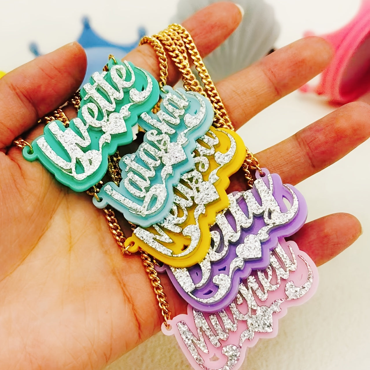 Personalize your style with a custom sparkling acrylic name necklace, adorned with a heart-shaped lace and personalized English nameplate. Available in a variety of colors, this classic piece is perfect for women looking to add a unique touch to their