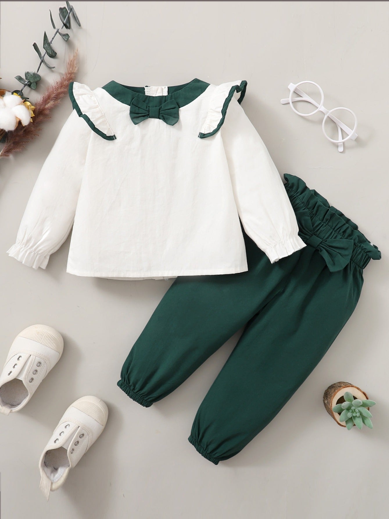 Two-piece set with lace trim top and pants for girls.