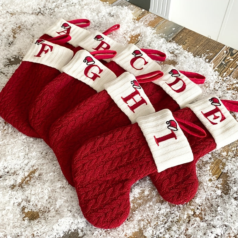 11" Christmas stocking with knitted alphabet design, perfect for hanging on the Xmas tree or using as a gift bag. Made of polyester.