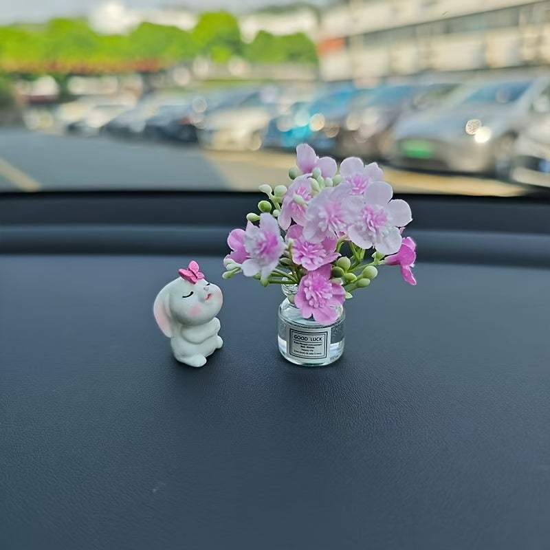 Miniature resin vase for car dashboard décor with healing figurine.