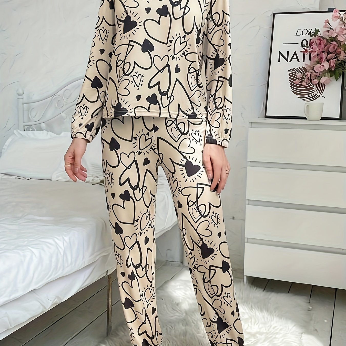 Women's lounge set with heart print, long sleeve top, crew neck, and elastic waistband pants for loungewear and sleepwear.