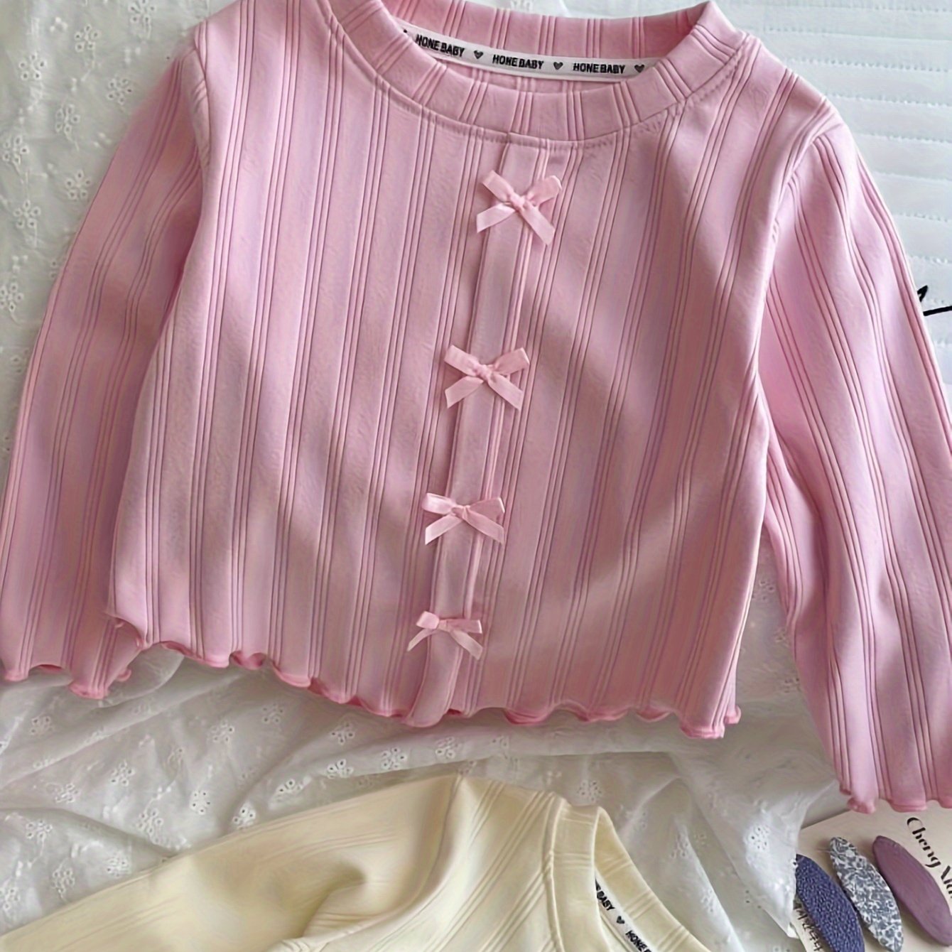 Stylish long-sleeve t-shirt with bow detail for girls, perfect for leisure and outdoor play, also makes a great gift.