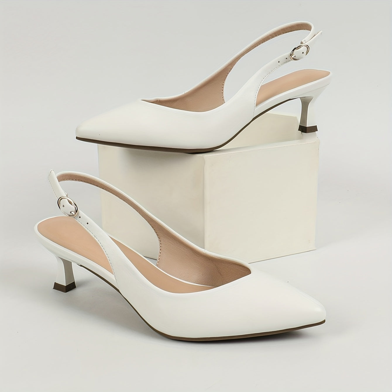 Stylish women's slingback shoes with pointed toe, mid-heel, solid color, and faux leather cover on rubber sole.