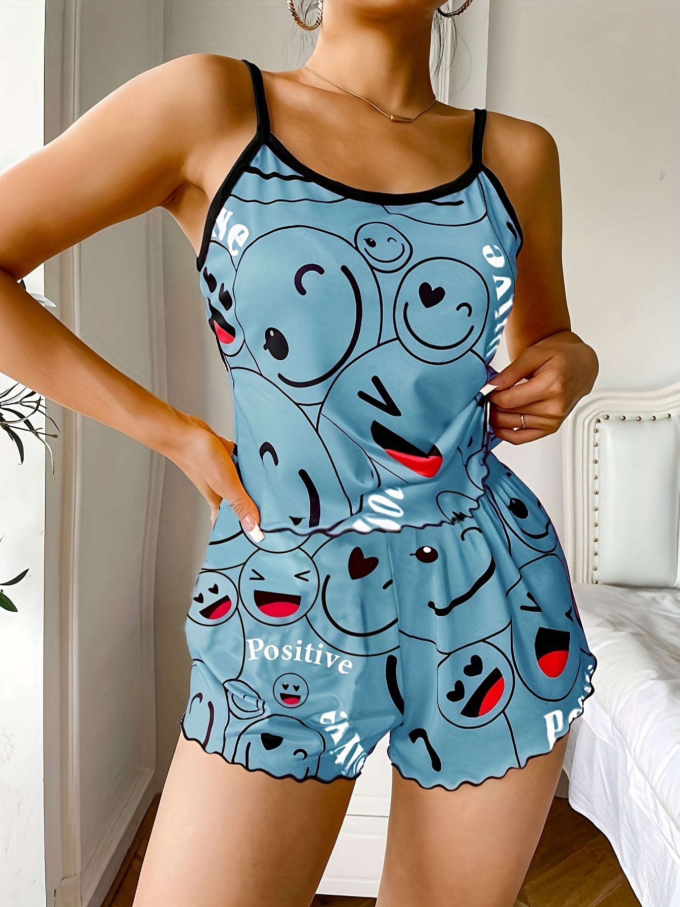 Women's sleepwear set with smiling face print cami top and elastic shorts.